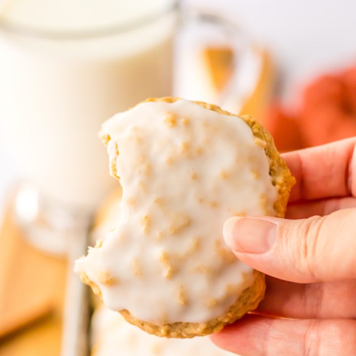Old Fashion Iced Oatmeal Cookies in hand with bite taken