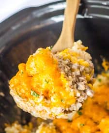 Slow Cooker Tatertot Casserole in spoon in slow cooker