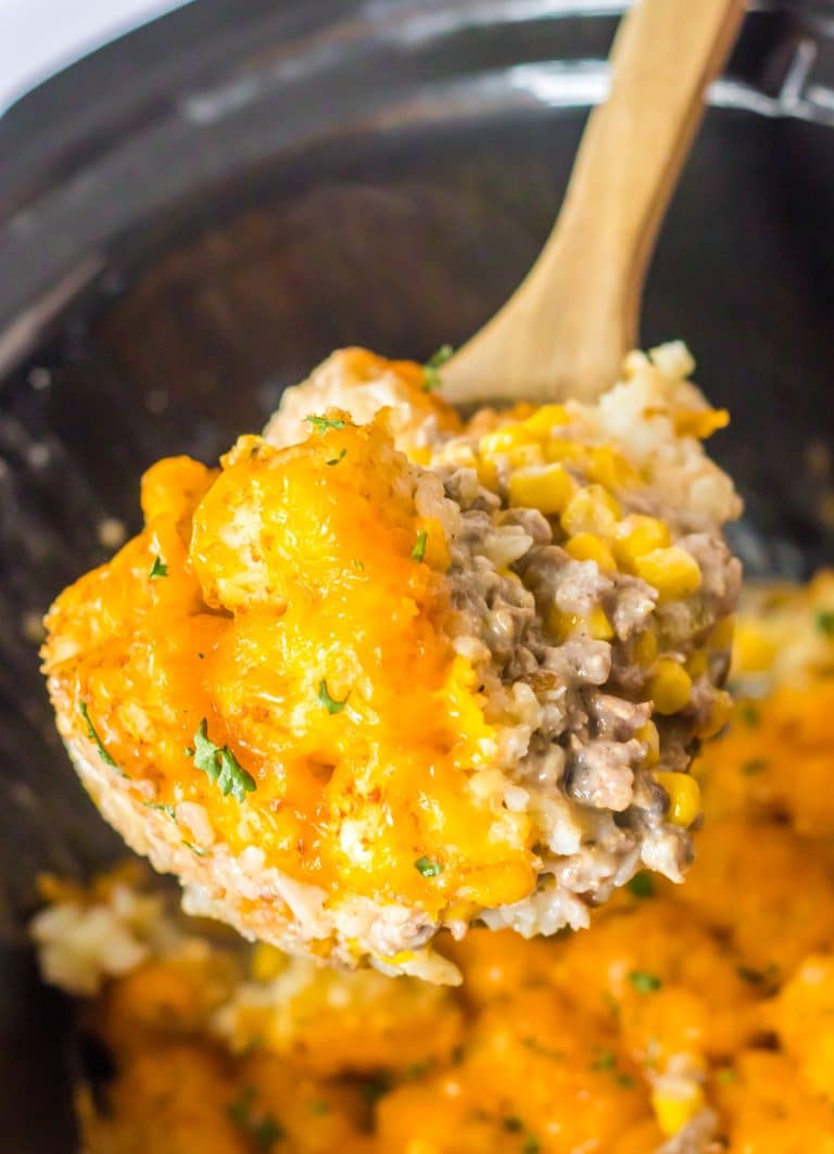 Slow Cooker Tatertot Casserole in spoon in slow cooker