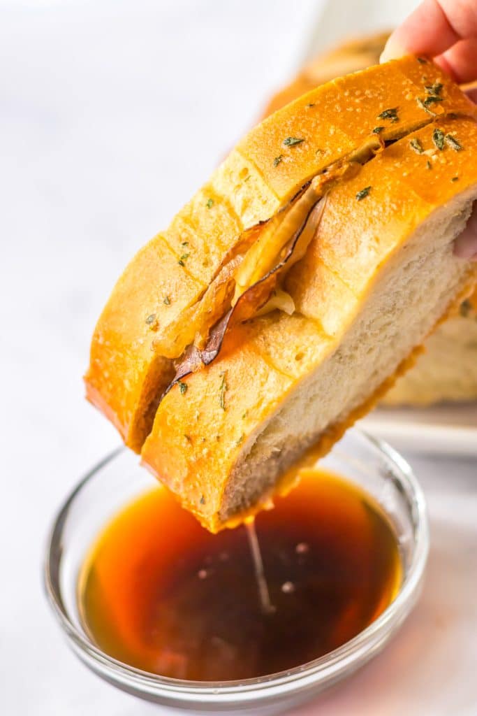 French Dip Pull Apart Bread being dipped
