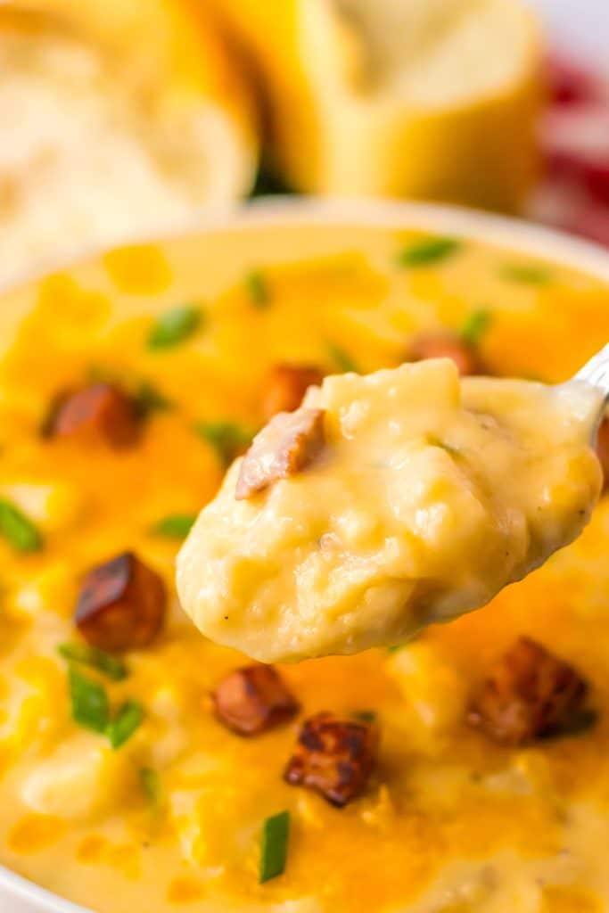 Slow Cooker Cheesy Potato Ham Soup in a spoon