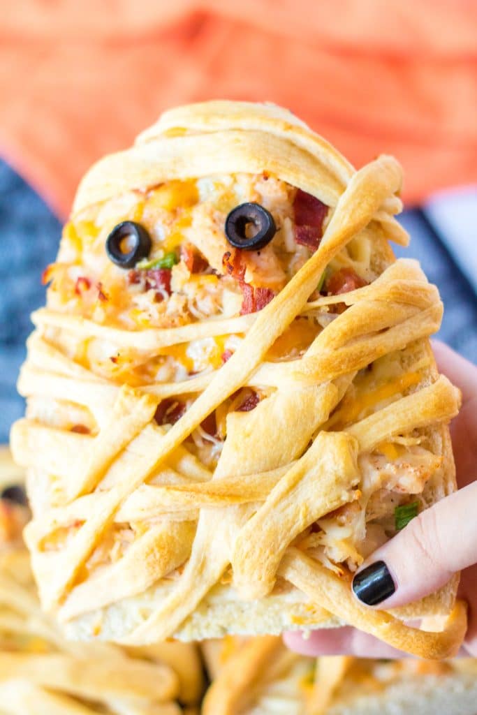 Chicken Bacon Ranch Mummy Pizza in hand