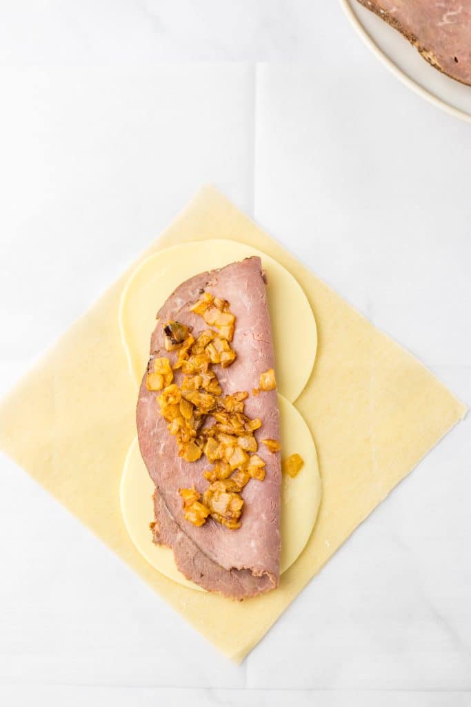 French Dip Egg Rolls ingredients on wrapper