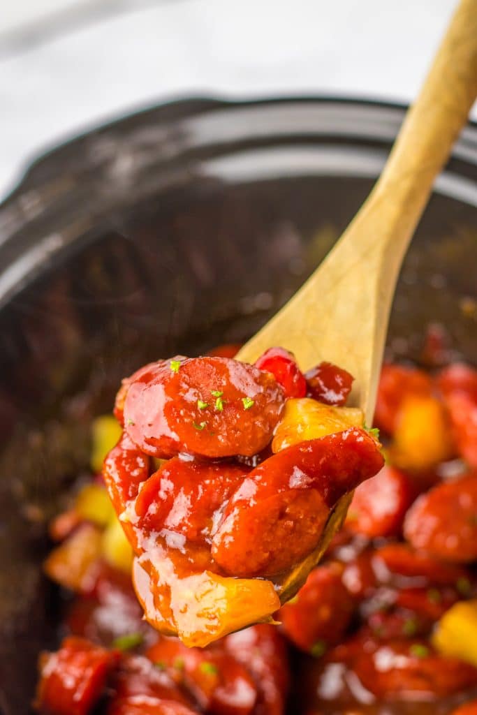 Slow Cooker Cranberry Pineapple Kielbasa Bites on spoon