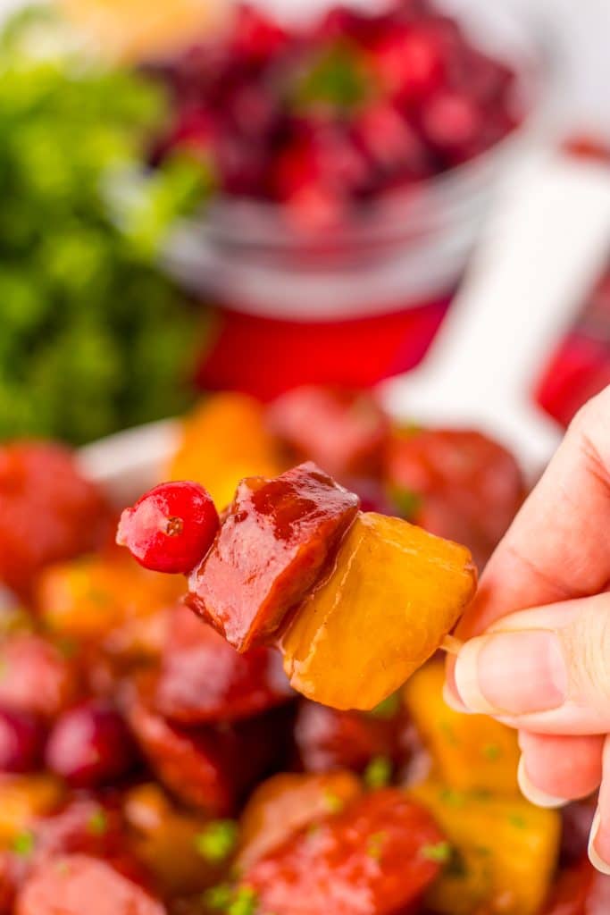 Slow Cooker Cranberry Pineapple Kielbasa Bites on toothpick