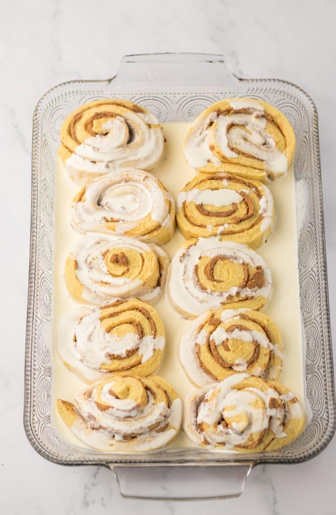 Grinch Cinnamon Rolls in pan with cream