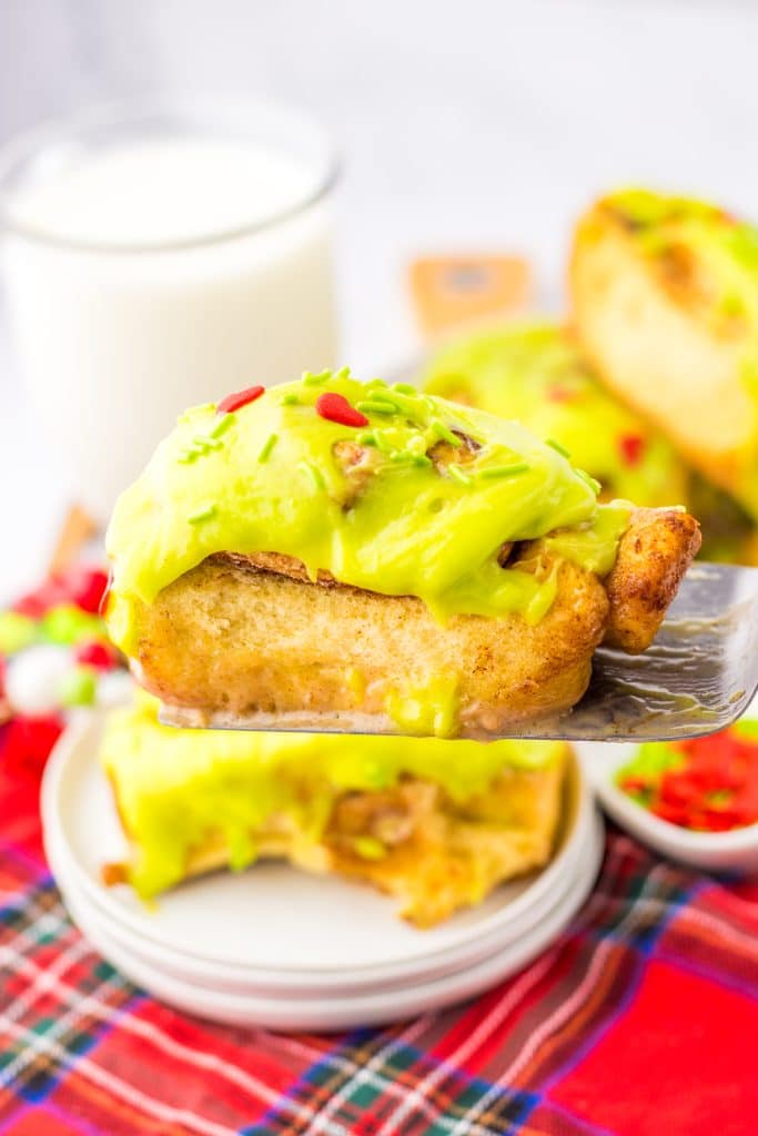 Grinch Cinnamon Rolls on spatula
