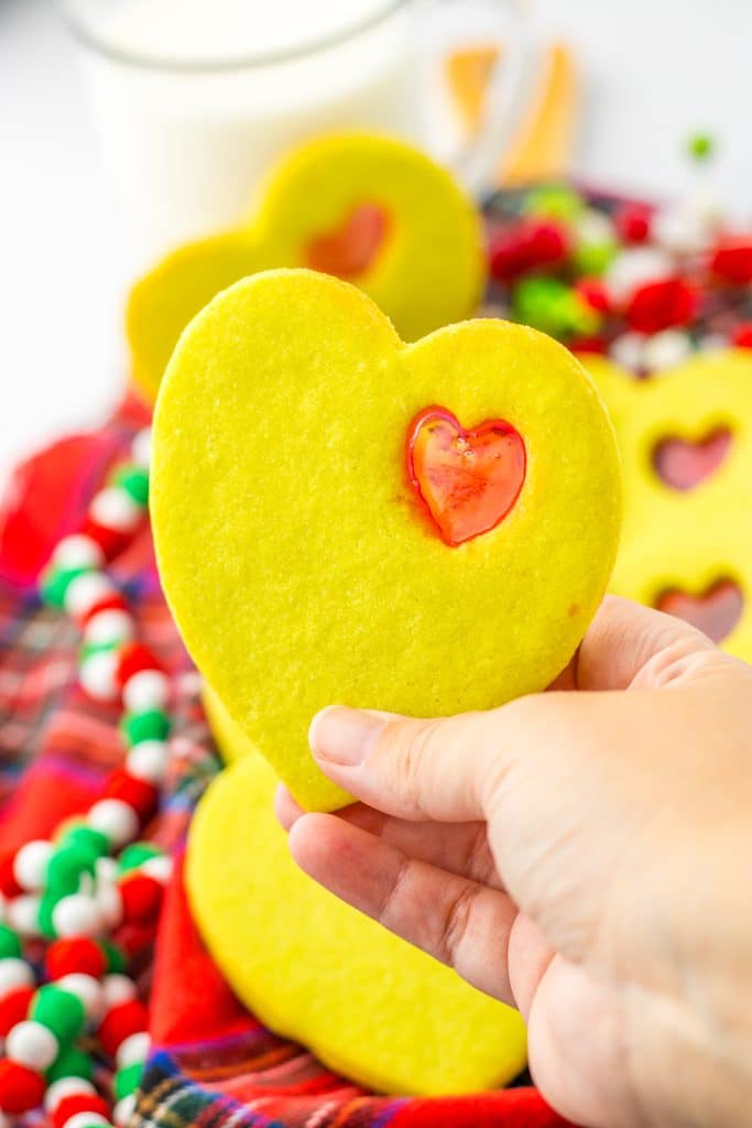 Grinch Stained Glass Cookies in hand