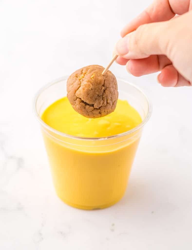 Carrot Cake Chick Truffles dipping in chocolate