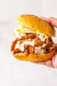 Slow Cooker BBQ Ranch Chicken Sandwiches in hand