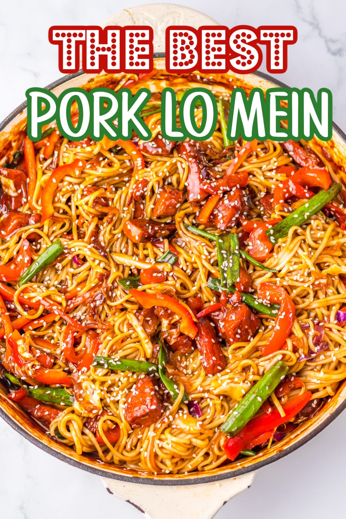 Close-up of homemade pork lo mein with tender pork slices, colorful vegetables, and noodles coated in a savory sauce, garnished with sesame seeds.