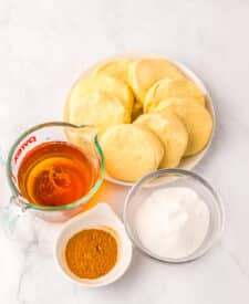 Raw biscuit dough with cinnamon sugar and reduced apple cider in small bowls