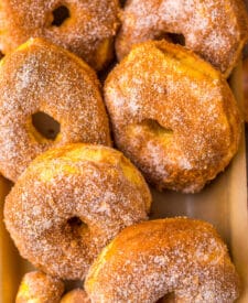 Homemade air fryer apple cider doughnuts coated in cinnamon sugar