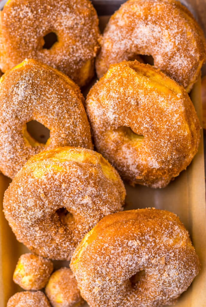 Homemade air fryer apple cider doughnuts coated in cinnamon sugar