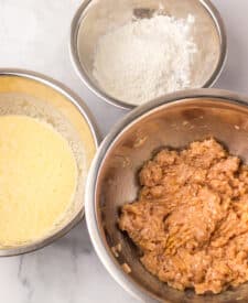 “Raw ground chicken mixture in a metal bowl ready to be shaped”