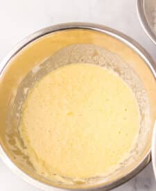 “Whisked egg and flour coating in bowls for nugget batter”