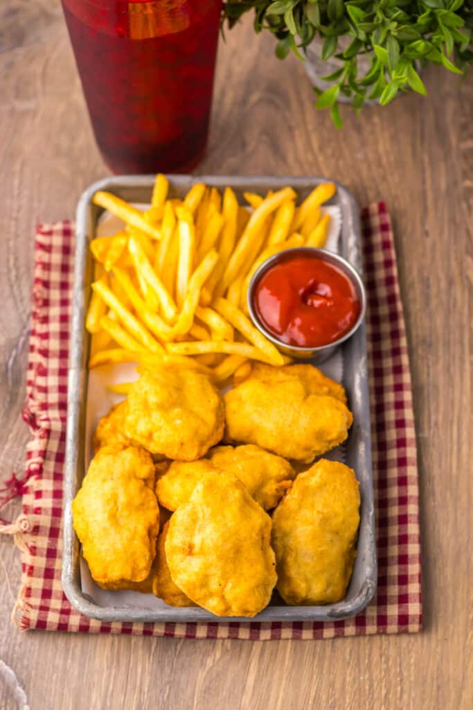 “Crispy golden copycat McDonald’s chicken nuggets served with fries and ketchup”