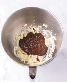 Chocolate cake with mousse layers being assembled for homemade Black Tie Mousse Cake."