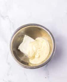 Chocolate cake with mousse layers being assembled for homemade Black Tie Mousse Cake."