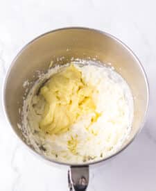 Chocolate cake with mousse layers being assembled for homemade Black Tie Mousse Cake."