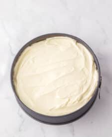 Chocolate cake with mousse layers being assembled for homemade Black Tie Mousse Cake."