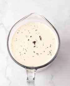 Chocolate cake with mousse layers being assembled for homemade Black Tie Mousse Cake."