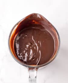 Chocolate cake with mousse layers being assembled for homemade Black Tie Mousse Cake."