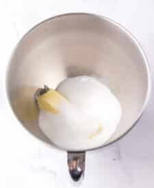 Chocolate cake with mousse layers being assembled for homemade Black Tie Mousse Cake."