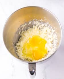 Chocolate cake with mousse layers being assembled for homemade Black Tie Mousse Cake."
