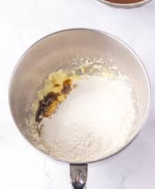 Chocolate cake with mousse layers being assembled for homemade Black Tie Mousse Cake."