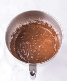 Chocolate cake with mousse layers being assembled for homemade Black Tie Mousse Cake."