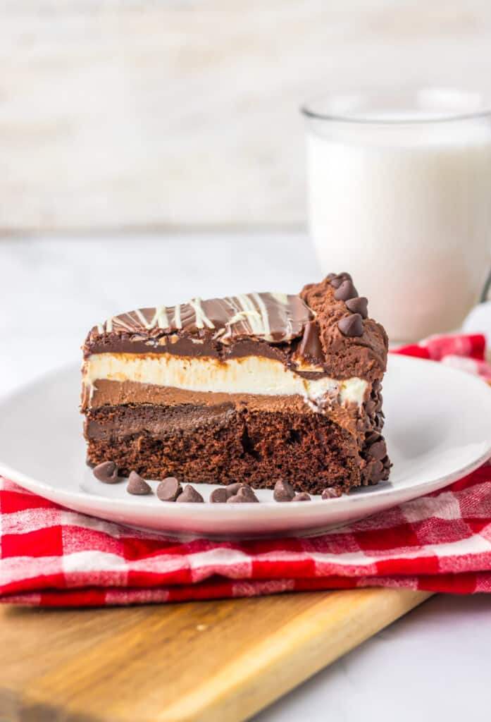 "Slice of homemade Olive Garden Black Tie Mousse Cake showing chocolate cake, mousse layers, and ganache."