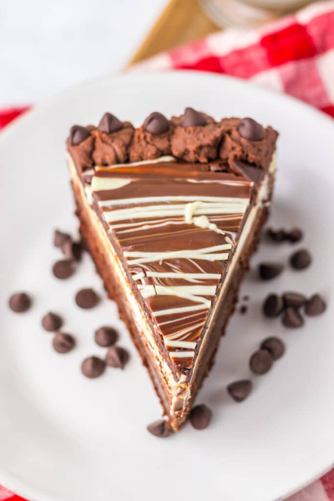 "Slice of homemade Olive Garden Black Tie Mousse Cake showing chocolate cake, mousse layers, and ganache."