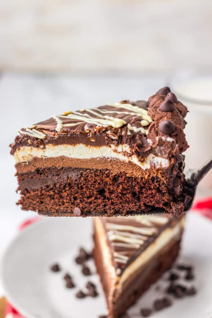 "Slice of homemade Olive Garden Black Tie Mousse Cake showing chocolate cake, mousse layers, and ganache."