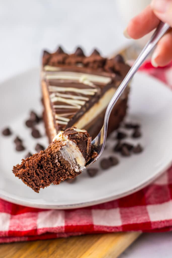 "Slice of homemade Olive Garden Black Tie Mousse Cake showing chocolate cake, mousse layers, and ganache."