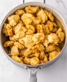 “Step-by-step photo showing battering and frying orange chicken”