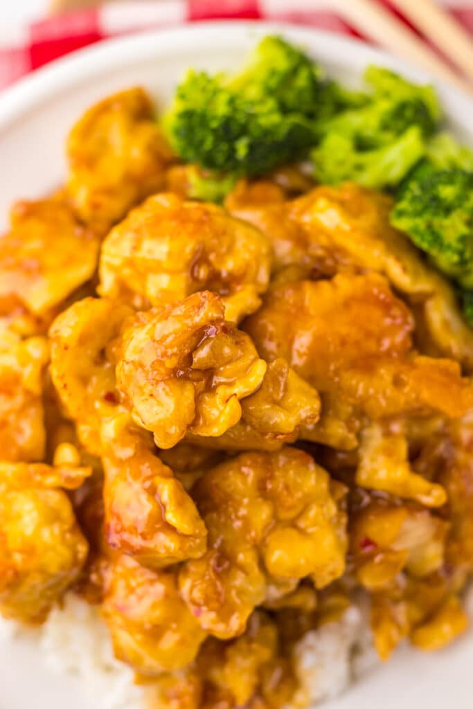 “Crispy Copycat Panda Express Orange Chicken served over white rice on a plate”