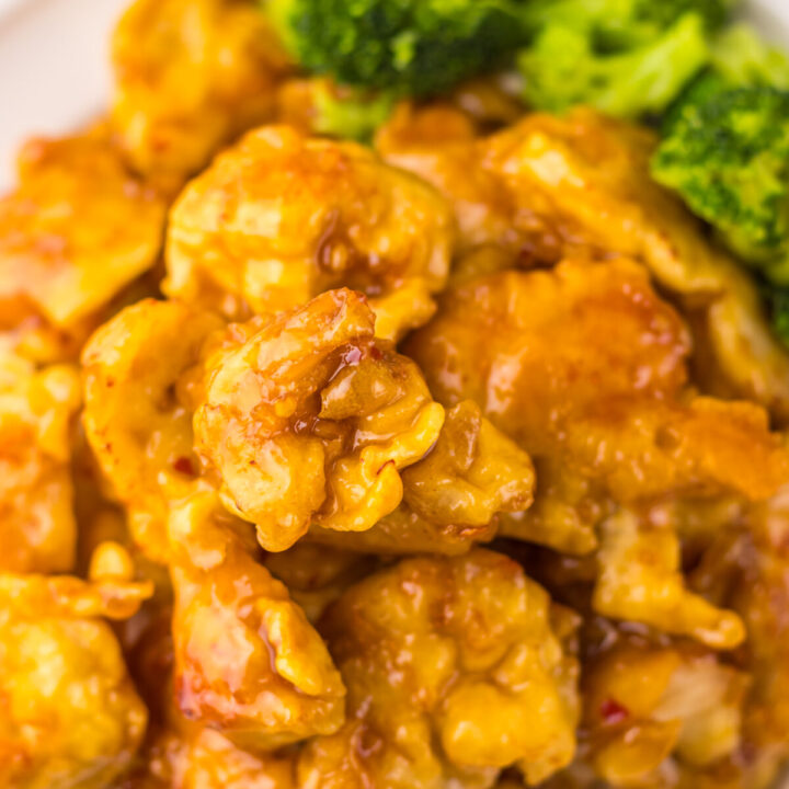 “Crispy Copycat Panda Express Orange Chicken served over white rice on a plate”