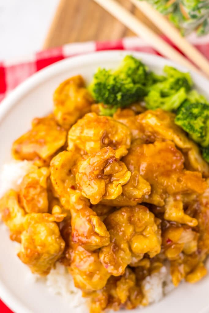 “Crispy Copycat Panda Express Orange Chicken served over white rice on a plate”