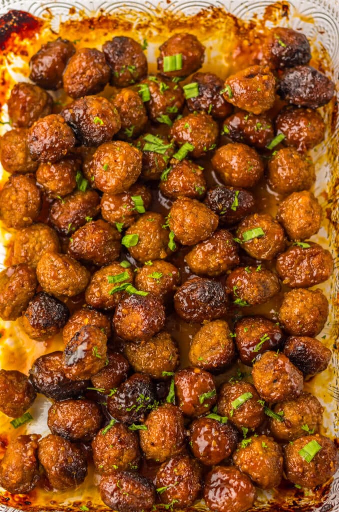 “Close-up of sweet and savory honey garlic meatballs in a 9x13 pan, coated in thick glaze”