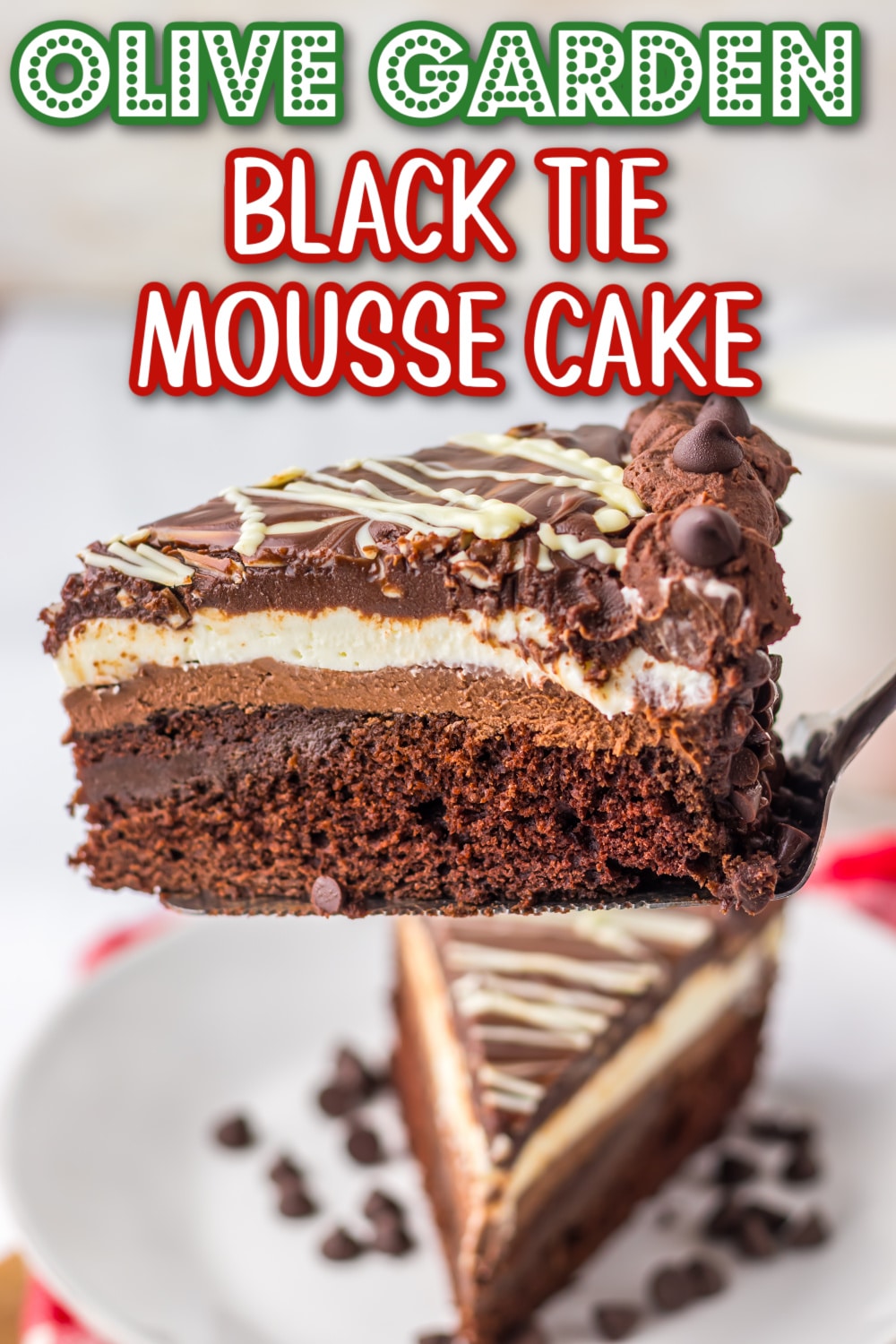 Slice of rich chocolate Black Tie Mousse Cake with layered cheesecake, mousse, and ganache served on a white plate