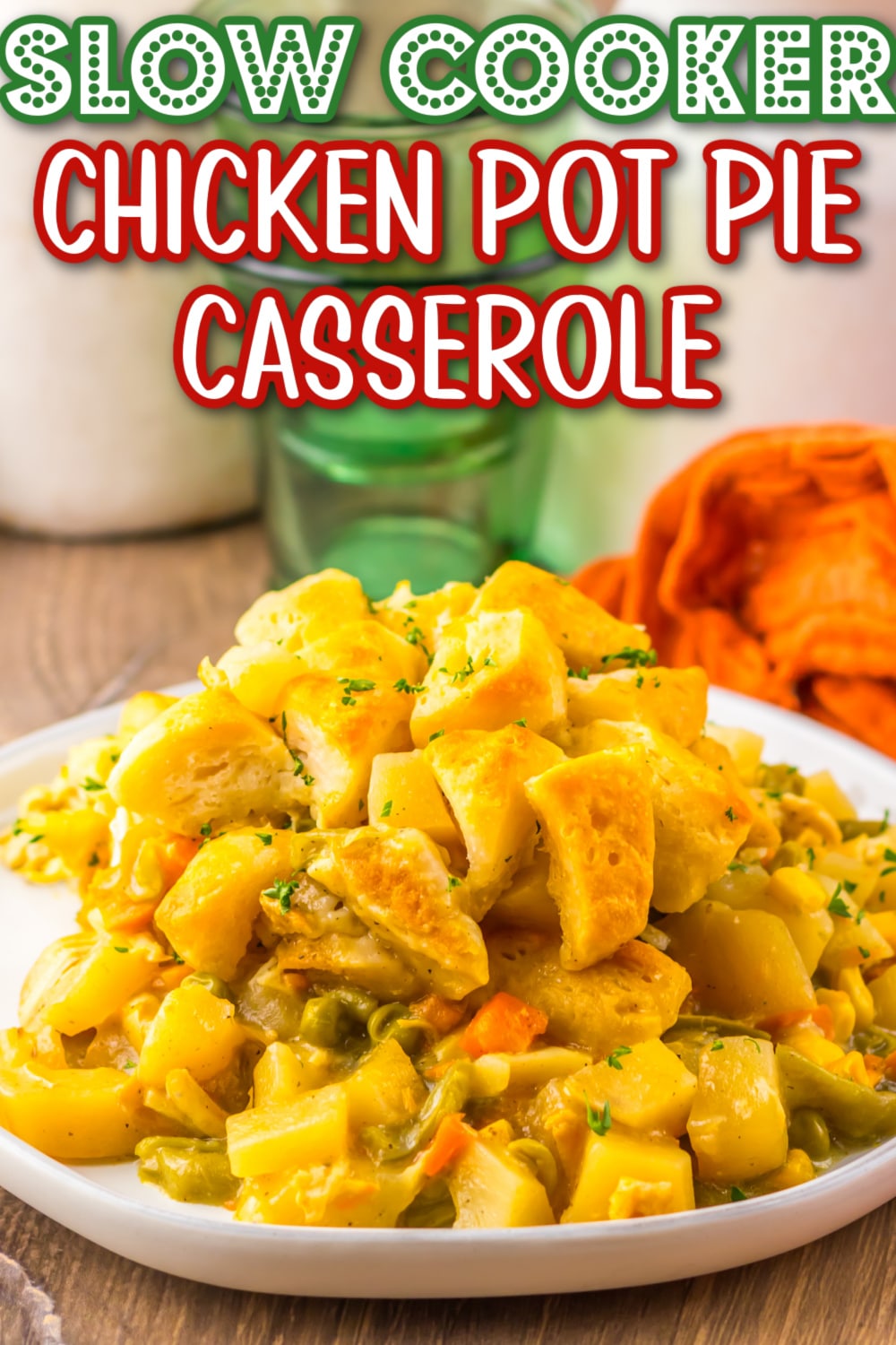 Creamy chicken pot pie filling with tender biscuits and vegetables, served fresh from the slow cooker in a cozy white dish.