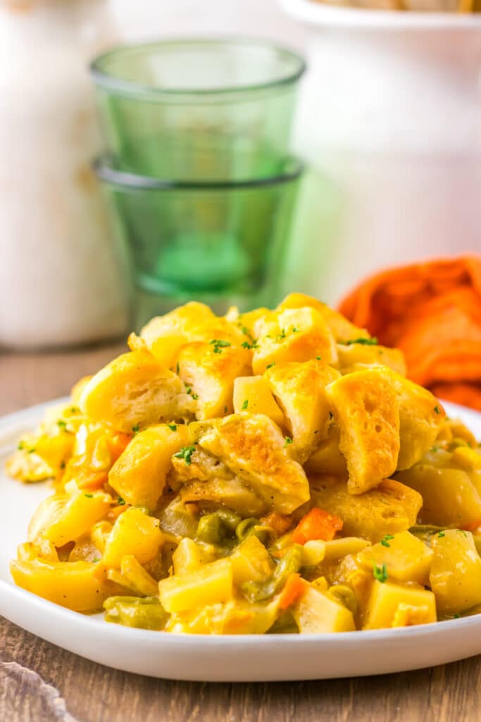 Zoomed-in shot of plated casserole showing biscuit layers and creamy chicken filling.