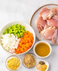 Ingredients for slow cooker chicken pot roast including chicken thighs, broth, and seasonings