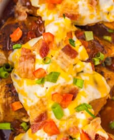Overhead view of cheesy Monterey Chicken topped with bacon and scallions