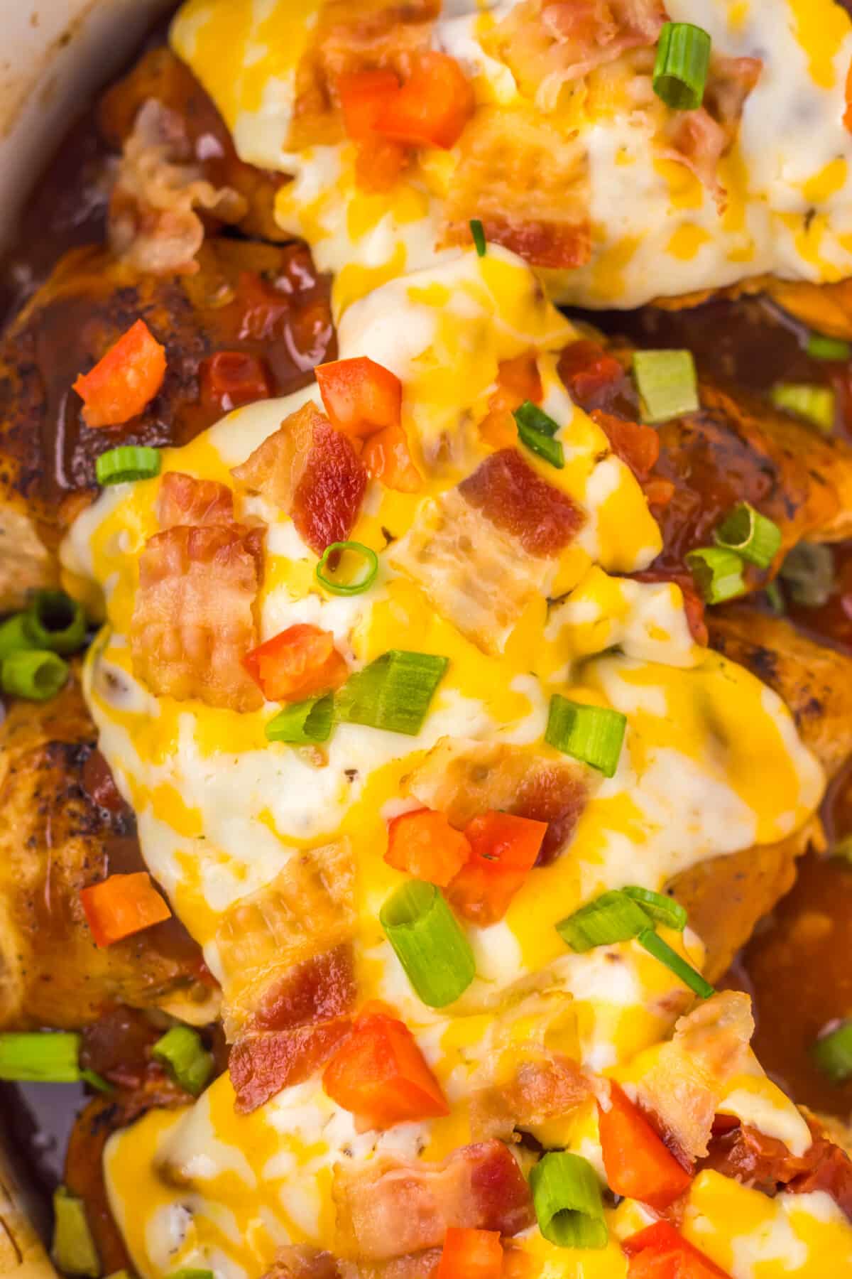 Overhead view of cheesy Monterey Chicken topped with bacon and scallions