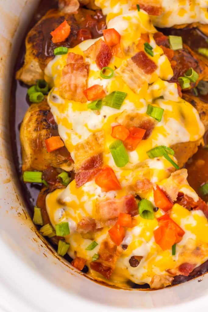Overhead view of cheesy Monterey Chicken topped with bacon and scallions