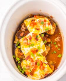 Overhead view of Monterey Chicken with melted cheese and bacon in slow cooker