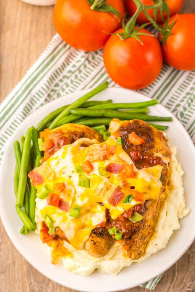 Overhead view of cheesy Monterey Chicken topped with bacon and scallions