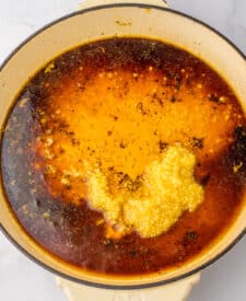 Garlic, honey, soy sauce, and vinegar mixture in a skillet before simmering, ready to become a sticky glaze.